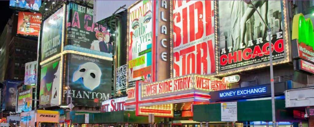 Illuminated Broadway theater marquees display show titles including The Phantom of the Opera.