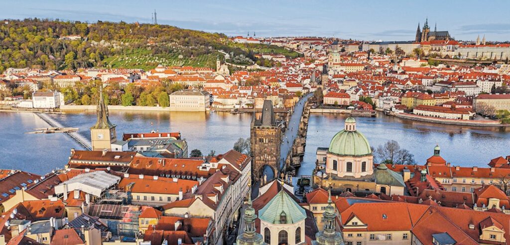 Aerial view of Prague's Old Town with the Vltava River, Charles Bridge, and Church of Our Lady.