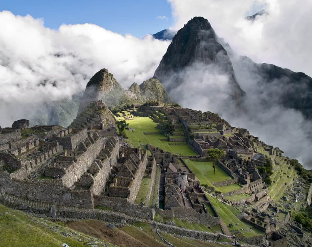 Machu Picchu's ancient stone ruins and terraces nestled among misty mountain peaks in Peru.
